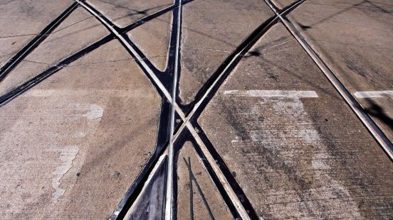 Intersecting crossing street-car tracks.