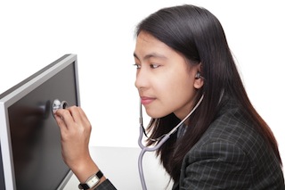 woman-listens-to-computer-with-stethoscope