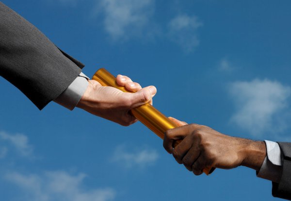 businessmen-passing-gold-baton